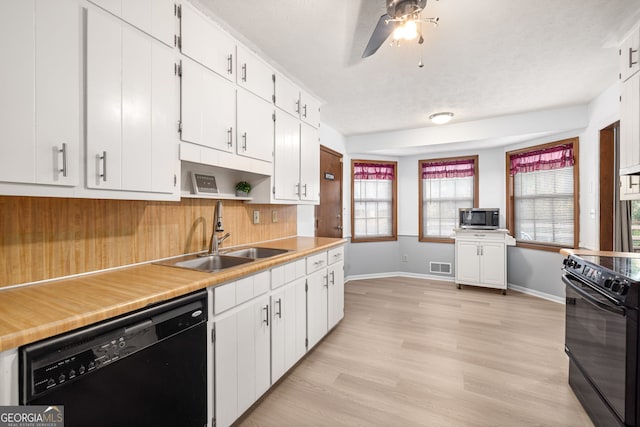 kitchen with white cabinetry, sink, and black appliances