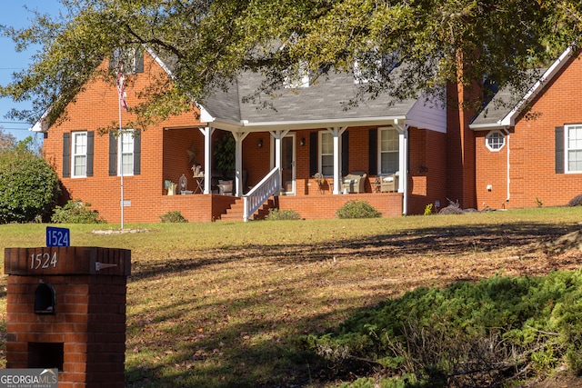 view of front of house with a porch and a front lawn