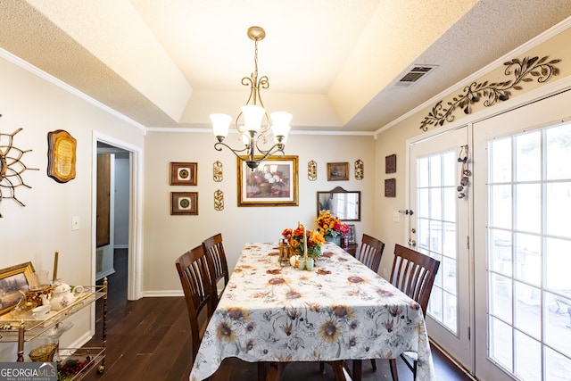 dining room featuring a raised ceiling, crown molding, and dark hardwood / wood-style floors