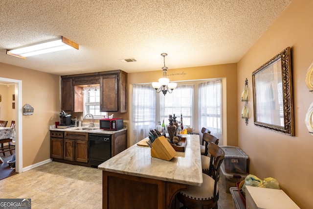 kitchen featuring light stone counters, a textured ceiling, sink, black appliances, and pendant lighting