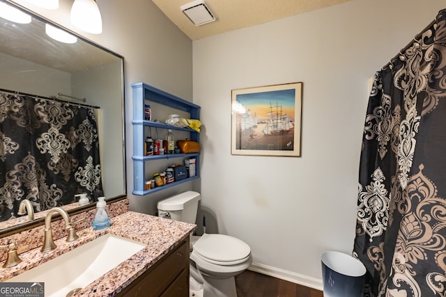 bathroom featuring hardwood / wood-style floors, vanity, a textured ceiling, and toilet