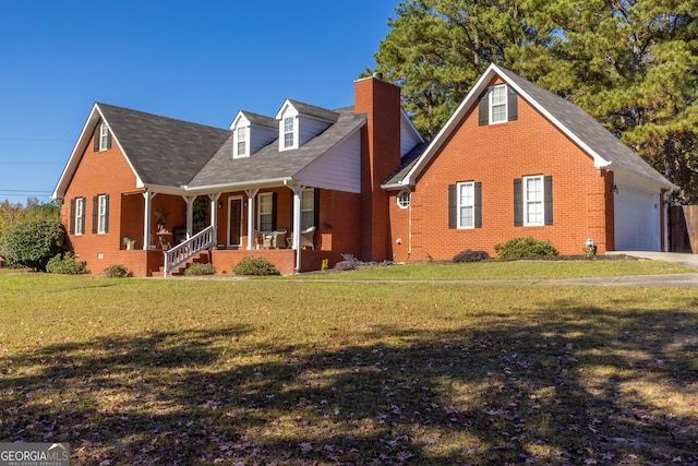 view of front of home with a porch, a garage, and a front lawn