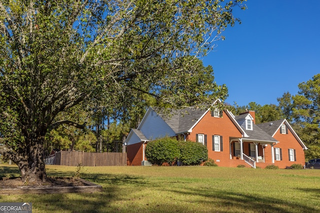 view of home's exterior with a lawn and a porch