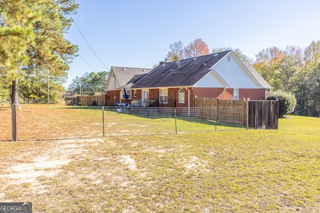 rear view of house with a lawn