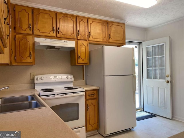 kitchen featuring a textured ceiling, plenty of natural light, sink, and white appliances