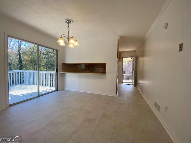 interior space featuring crown molding, light tile patterned floors, a chandelier, and a textured ceiling