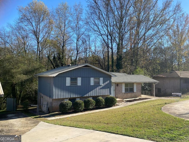 tri-level home with a front lawn and a carport