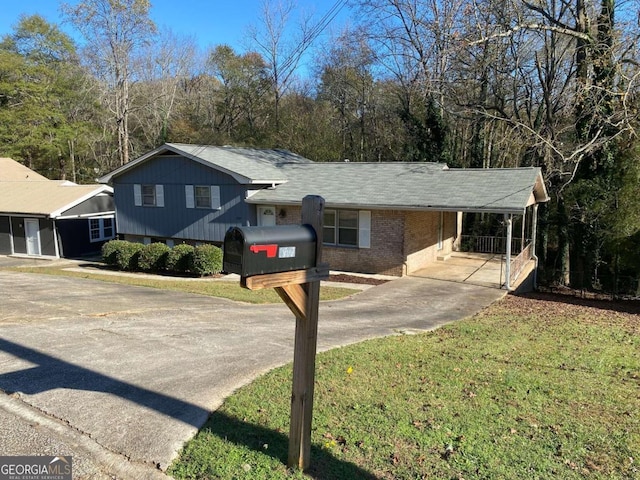 tri-level home featuring a front yard and a carport