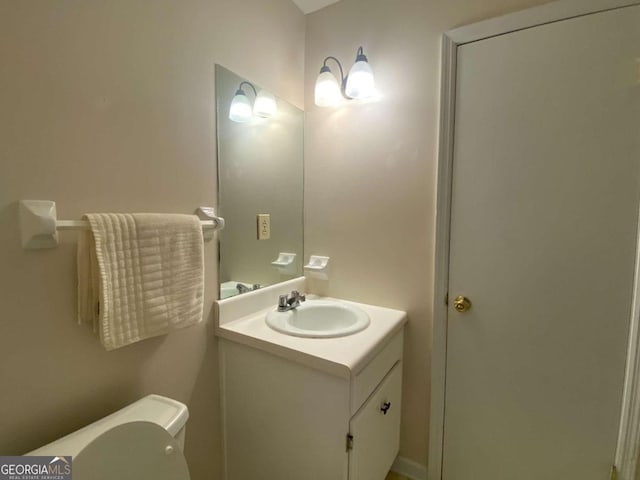 bathroom featuring vanity and toilet