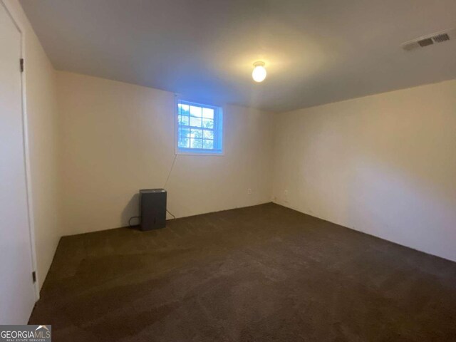 basement with dark colored carpet