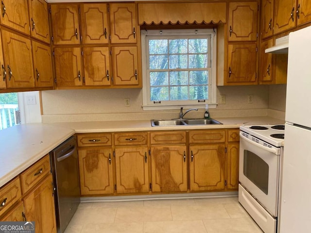 kitchen with white appliances, sink, and light tile patterned floors