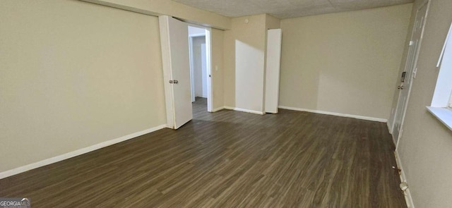 spare room with dark hardwood / wood-style flooring