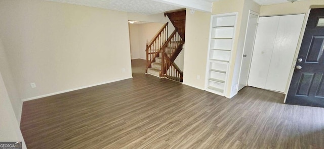 interior space featuring dark hardwood / wood-style flooring and a textured ceiling