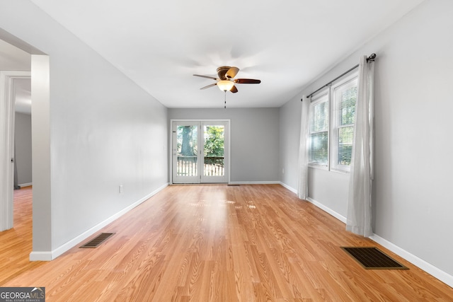 spare room with light wood-type flooring and ceiling fan