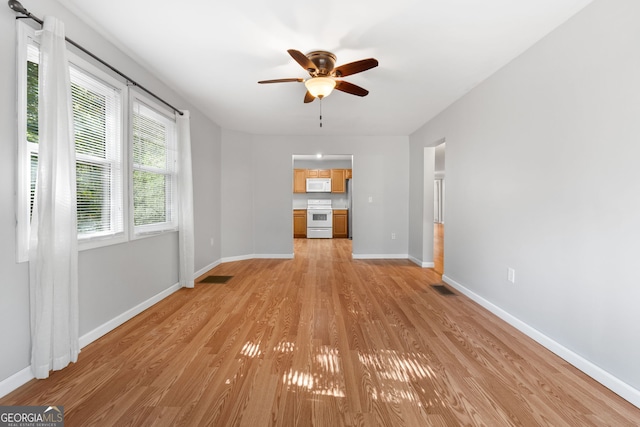 unfurnished living room with ceiling fan and light wood-type flooring