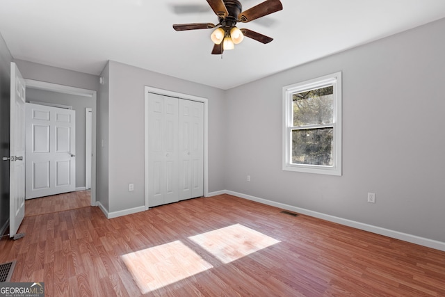 465 Haynie Rd, Moreland, GA 30259 - unfurnished bedroom with light wood-style floors, baseboards, a closet, and a ceiling fan