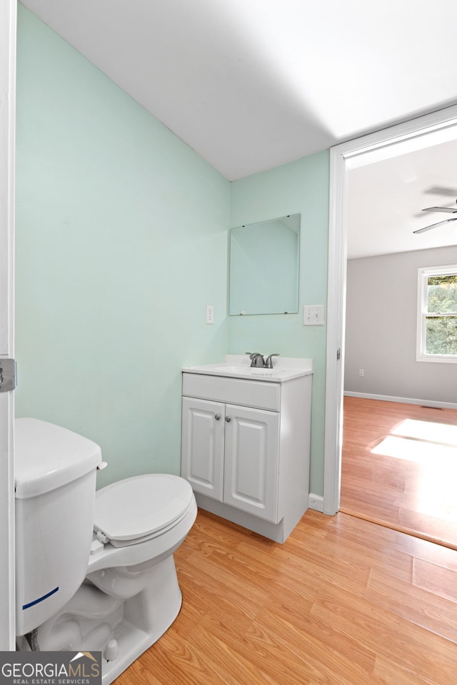 465 Haynie Rd, Moreland, GA 30259 - bathroom with vanity, toilet, wood finished floors, and a ceiling fan