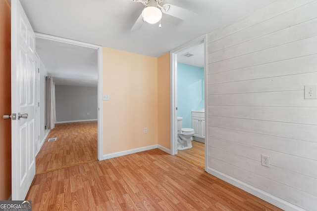 empty room with ceiling fan and light wood-type flooring