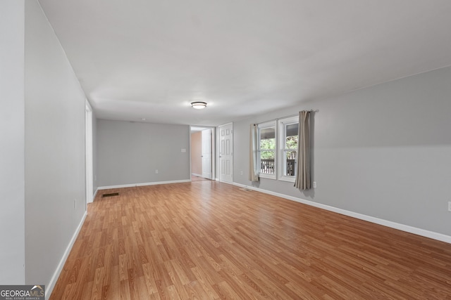 spare room with light hardwood / wood-style floors