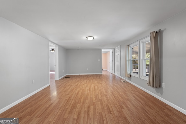 empty room with light hardwood / wood-style floors