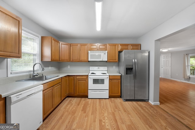 465 Haynie Rd, Moreland, GA 30259 - kitchen with white appliances, a sink, light wood-style flooring, and light countertops
