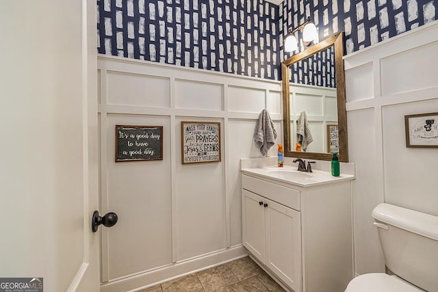 bathroom featuring tile patterned floors, vanity, and toilet