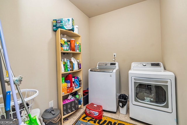 washroom with independent washer and dryer and tile patterned floors