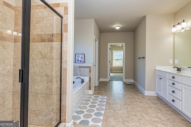 bathroom with vanity and shower with separate bathtub