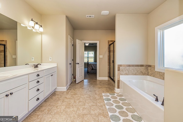 bathroom with a wealth of natural light, vanity, and shower with separate bathtub