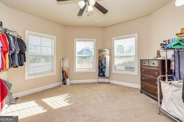 interior space featuring ceiling fan, a closet, and light colored carpet