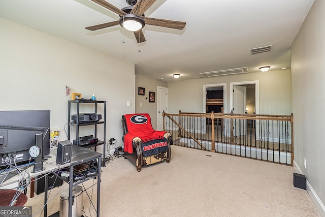 sitting room with carpet floors and ceiling fan