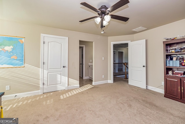 unfurnished bedroom with ceiling fan and light colored carpet