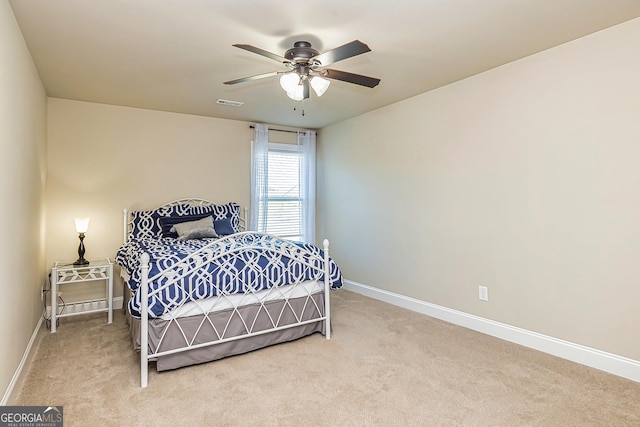 bedroom featuring ceiling fan and light carpet