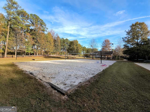 view of property's community featuring volleyball court and a lawn