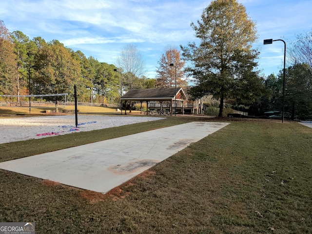 view of home's community with a lawn and volleyball court