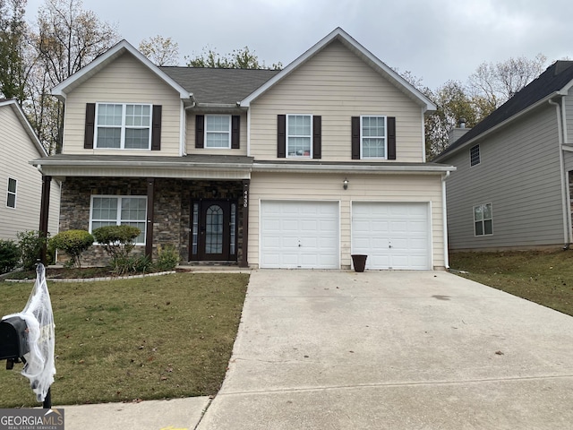 view of front of home featuring a front yard and a garage