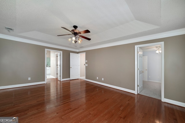 unfurnished room featuring dark hardwood / wood-style floors, ceiling fan, a textured ceiling, and a tray ceiling