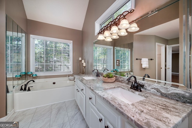 bathroom featuring a bathtub, lofted ceiling, and vanity