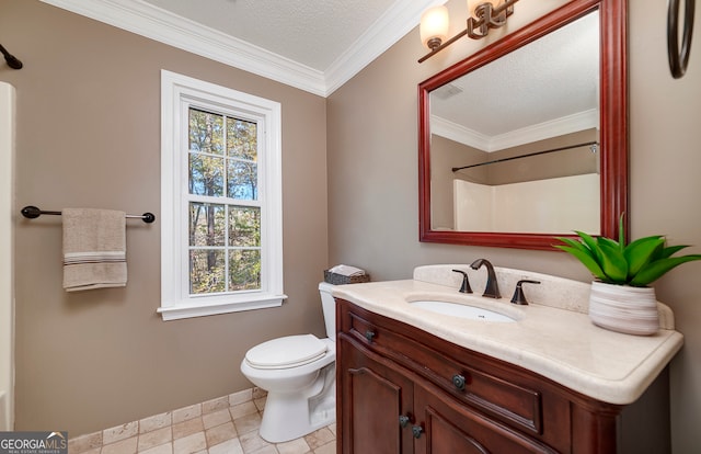 bathroom featuring vanity, toilet, ornamental molding, and a textured ceiling