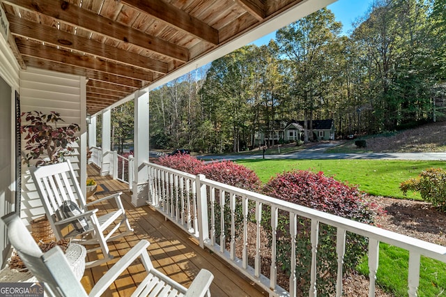 deck with covered porch and a lawn