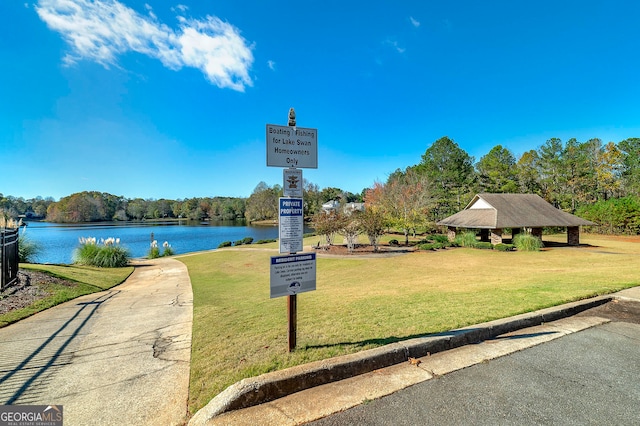 view of home's community with a gazebo, a lawn, and a water view