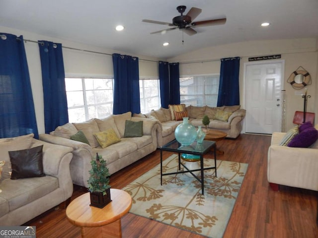 living room featuring ceiling fan, dark hardwood / wood-style flooring, and vaulted ceiling