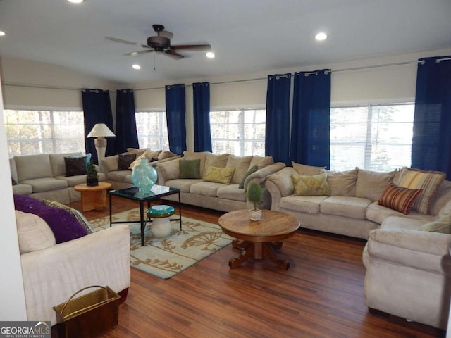 living room featuring ceiling fan and dark hardwood / wood-style flooring