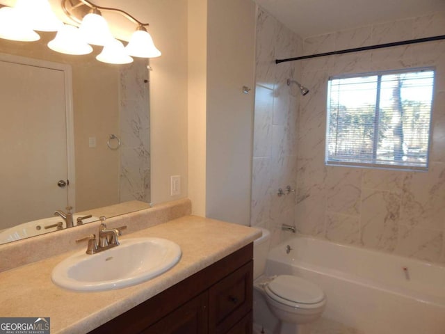 full bathroom with toilet, vanity, and tiled shower / bath combo