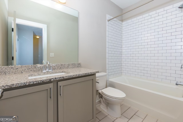 full bathroom featuring tile patterned floors, tiled shower / bath, vanity, and toilet