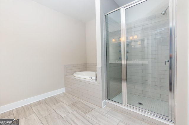 bathroom featuring shower with separate bathtub