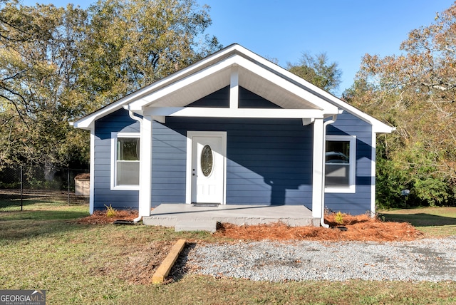 bungalow-style home with a front yard