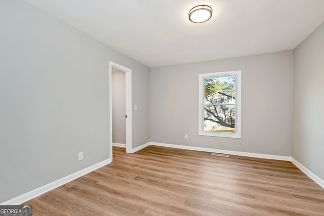 spare room with light hardwood / wood-style floors