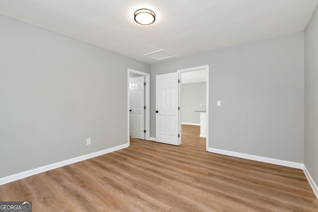 unfurnished bedroom with light wood-type flooring