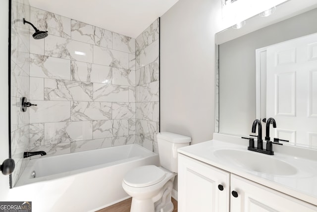 full bathroom with vanity, toilet, and tiled shower / bath